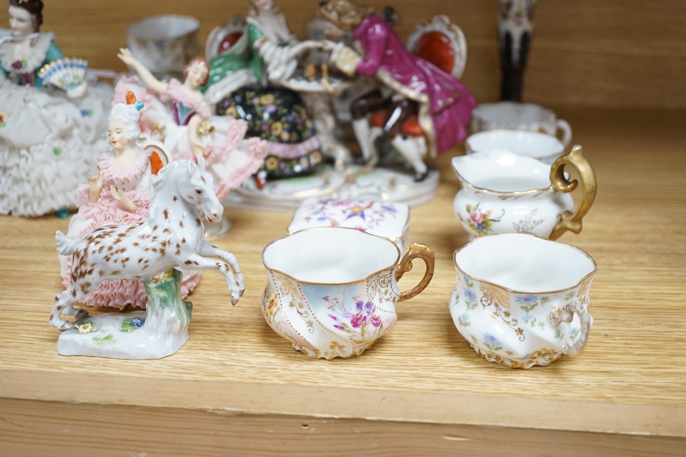 A group of Continental porcelain cabinet cups and saucers, a vase, crinoline figures and a Meissen horse, horse 9 cms high